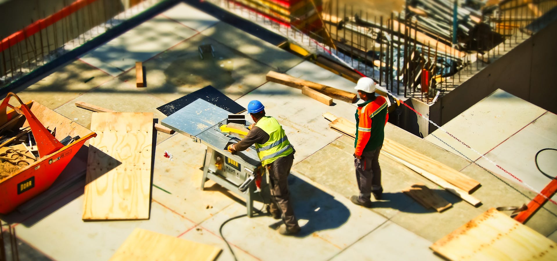 UK construction workers in hi-vis vests and safety gear on site